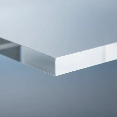 A close-up showing the edge and surface of a thick, high-quality acrylic panel, illustrating its clarity and substantial feel